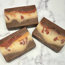 Load image into Gallery viewer, brown soap bar with a white stipe in the middle that is mixed with gold and red

